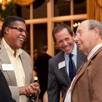 Richard and Dan DeVos talking with guests at an event.